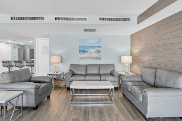 4450 Gulf Blvd Unit 114, St Pete Beach, FL 33706 - living room with wood walls and wood finished floors