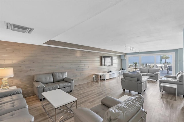 4450 Gulf Blvd Unit 114, St Pete Beach, FL 33706 - living room featuring wood walls and wood finished floors