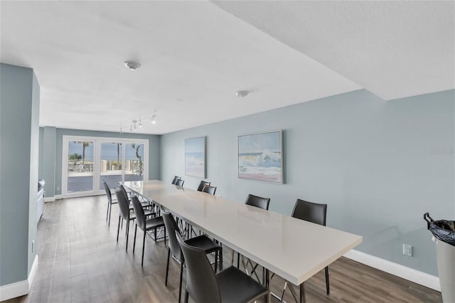 4450 Gulf Blvd Unit 114, St Pete Beach, FL 33706 - dining room with wood finished floors and track lighting