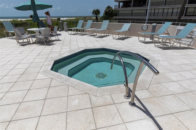 4450 Gulf Blvd Unit 114, St Pete Beach, FL 33706 - view of swimming pool featuring a hot tub and a patio area