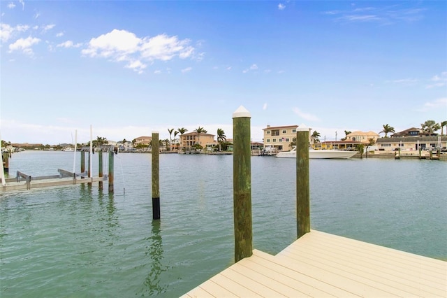 dock area with a residential view, a water view, and boat lift