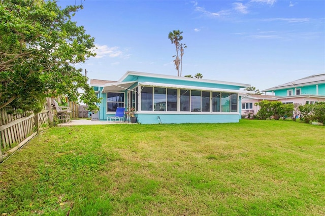 rear view of property with a sunroom, a yard, and fence private yard