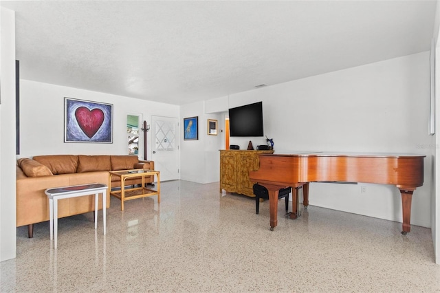 living area with speckled floor