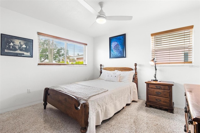bedroom featuring light speckled floor, a ceiling fan, and baseboards