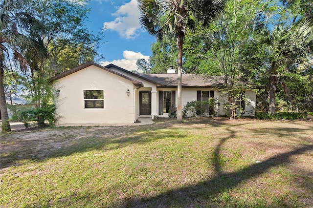 view of front facade with a front lawn and stucco siding