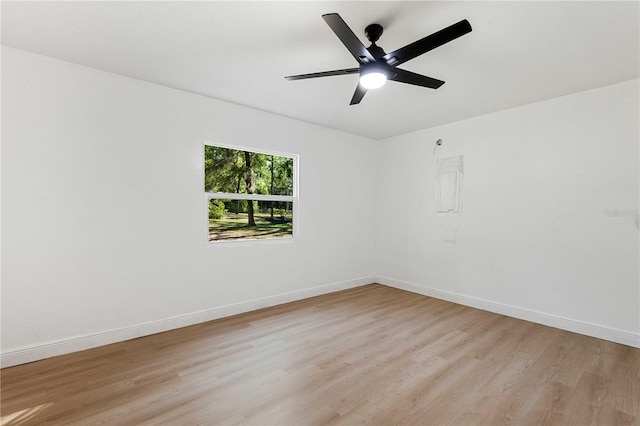 unfurnished room with baseboards, a ceiling fan, and light wood-style flooring