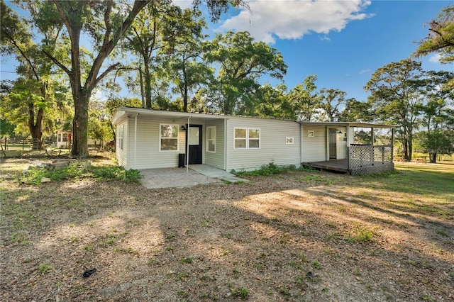 rear view of property with a wooden deck