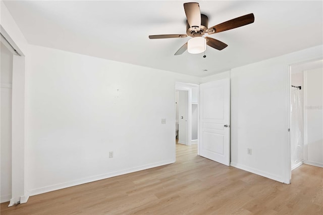 unfurnished bedroom featuring light wood-style floors, a closet, a ceiling fan, and baseboards