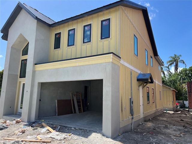 812 W Braddock St, Tampa, FL 33603 - view of front facade featuring a garage, board and batten siding, and stucco siding