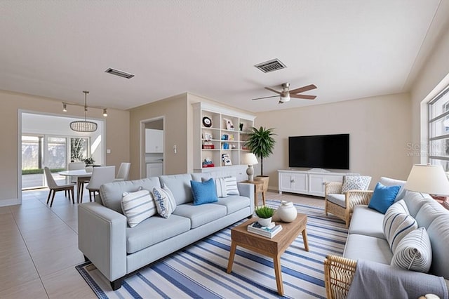 233 45th Ave, St Pete Beach, FL 33706 - living room featuring healthy amount of natural light, ceiling fan, and baseboards