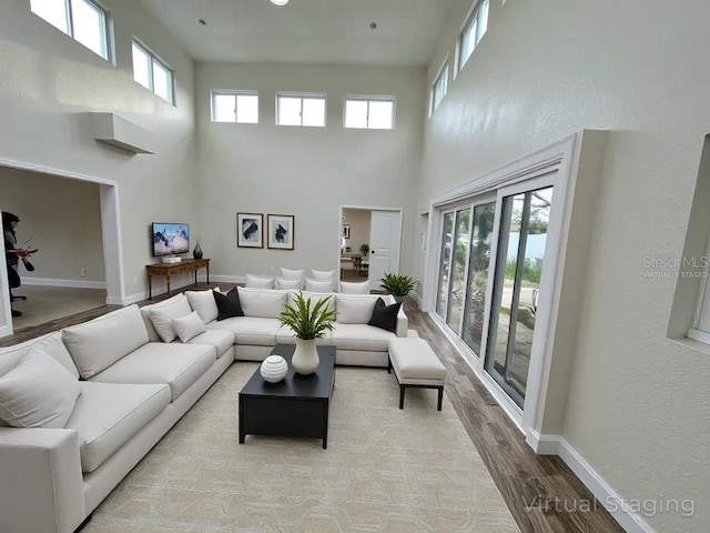 233 45th Ave, St Pete Beach, FL 33706 - living area featuring a high ceiling and light wood-style flooring