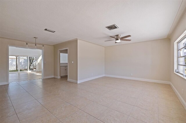 233 45th Ave, St Pete Beach, FL 33706 - empty room with light tile patterned floors, a ceiling fan, and a textured ceiling