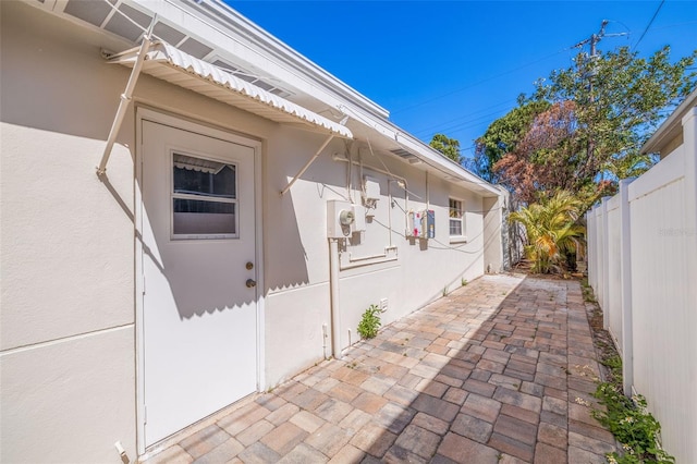 233 45th Ave, St Pete Beach, FL 33706 - view of property exterior featuring stucco siding and a patio area