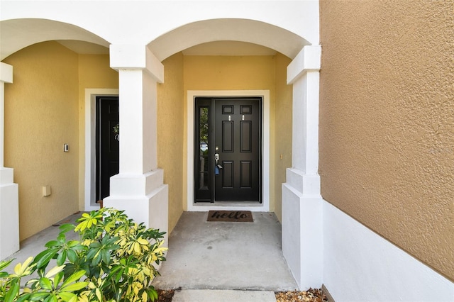 doorway to property with stucco siding