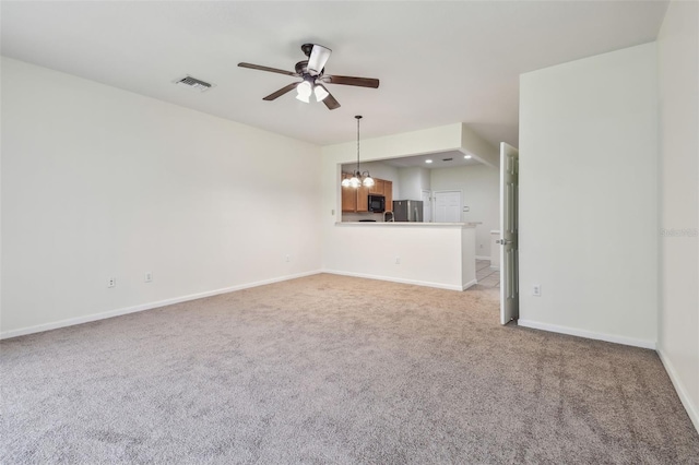 unfurnished living room with light colored carpet, baseboards, a ceiling fan, and visible vents