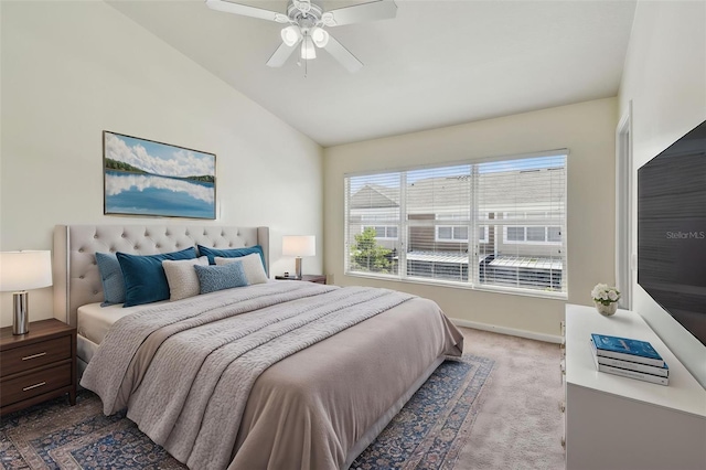 bedroom featuring baseboards, lofted ceiling, a ceiling fan, and light carpet
