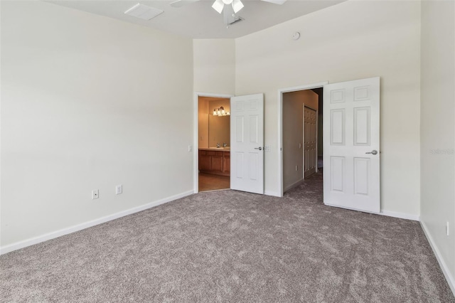 unfurnished bedroom featuring carpet floors, ensuite bath, and baseboards