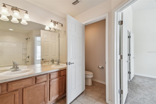 bathroom featuring a sink, walk in shower, double vanity, toilet, and visible vents