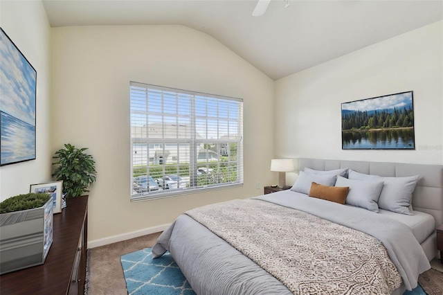 bedroom with ceiling fan, vaulted ceiling, carpet flooring, and baseboards