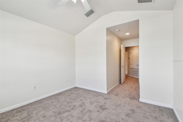 carpeted empty room featuring lofted ceiling, visible vents, baseboards, and ceiling fan