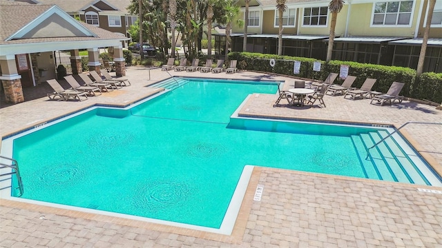 community pool with a patio area