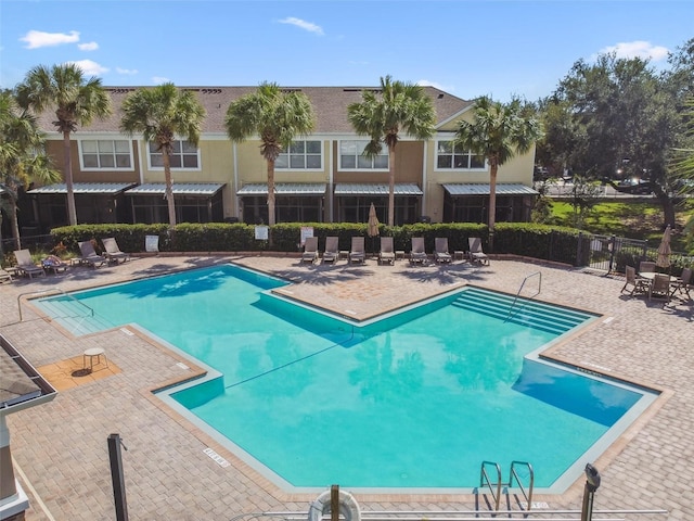 pool featuring fence and a patio
