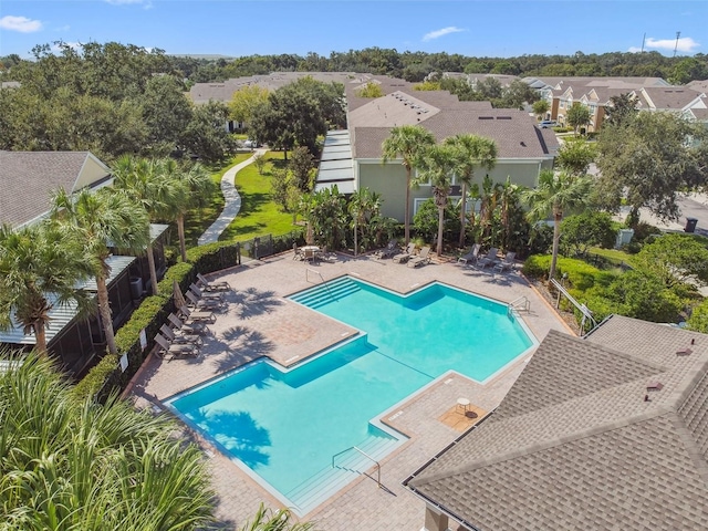 community pool featuring a residential view and a patio