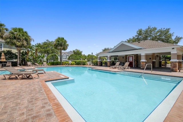 community pool featuring fence and a patio