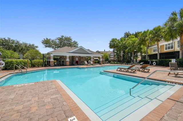 pool with fence and a patio area