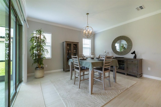 dining area featuring visible vents, baseboards, a notable chandelier, and ornamental molding