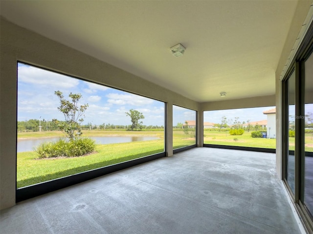 unfurnished sunroom with a water view and a wealth of natural light