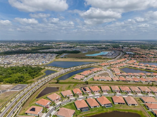 drone / aerial view with a residential view and a water view