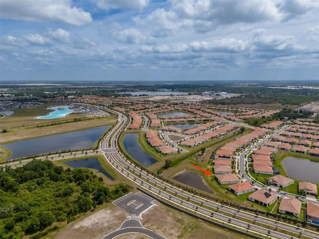 drone / aerial view featuring a residential view and a water view