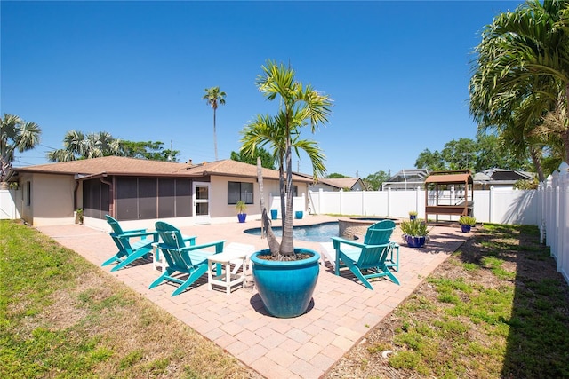 view of patio / terrace with a sunroom and a fenced backyard