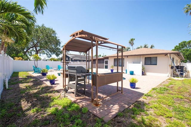exterior space featuring a patio area, a fenced backyard, stucco siding, and an outdoor living space