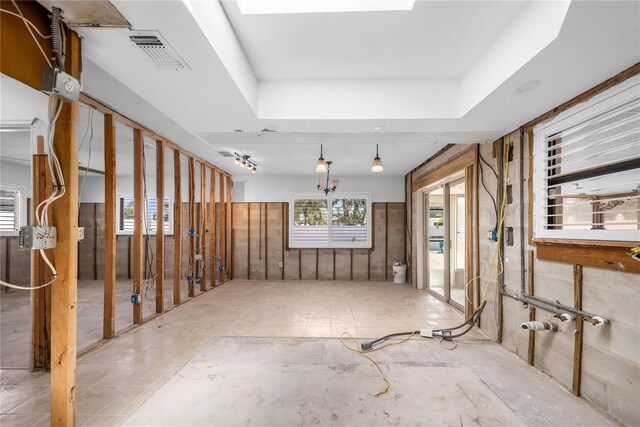 interior space with visible vents and a raised ceiling