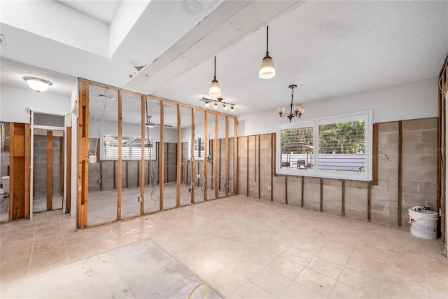 unfurnished room featuring a notable chandelier