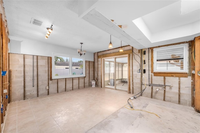 interior space with visible vents and an inviting chandelier