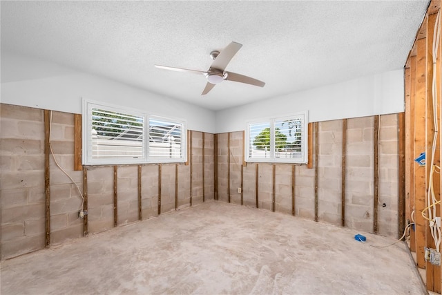 empty room with a textured ceiling and a ceiling fan