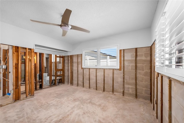 interior space featuring a ceiling fan and a textured ceiling