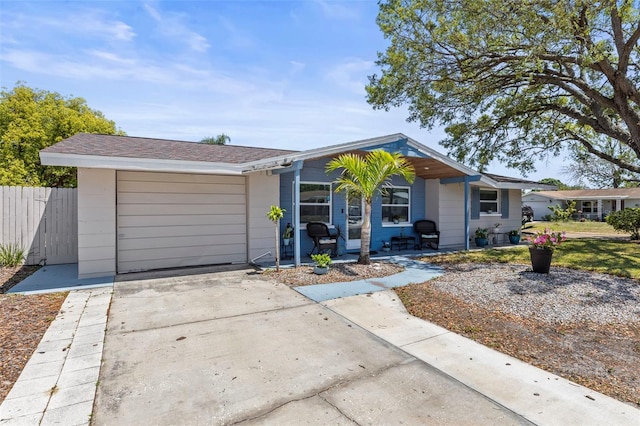 1344 Dartmouth Dr, Holiday, FL 34691 - ranch-style house with covered porch, an attached garage, fence, and driveway