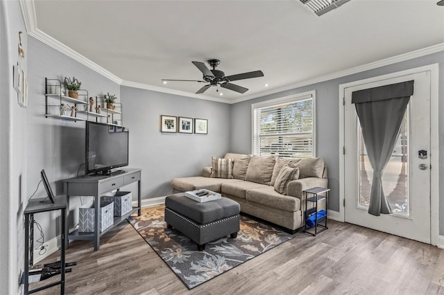 1344 Dartmouth Dr, Holiday, FL 34691 - living area featuring wood finished floors, visible vents, a ceiling fan, and ornamental molding