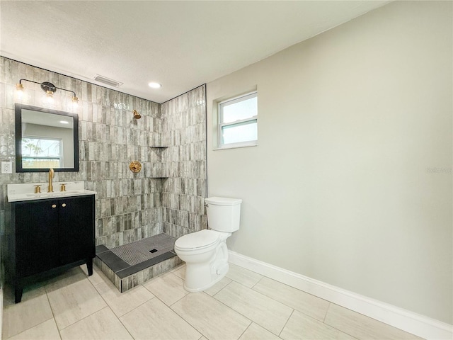 8648 78th Pl, Seminole, FL 33777 - full bath with toilet, tiled shower, vanity, baseboards, and tile patterned floors