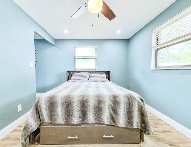 8648 78th Pl, Seminole, FL 33777 - bedroom with wood finished floors, baseboards, and a ceiling fan