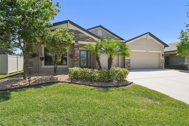 craftsman-style home with stone siding, driveway, a front yard, and a garage