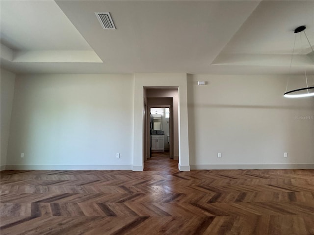 7208 N Glen Ave, Tampa, FL 33614 - empty room with a tray ceiling, visible vents, and baseboards