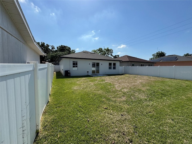 7208 N Glen Ave, Tampa, FL 33614 - back of house featuring a fenced backyard and a yard