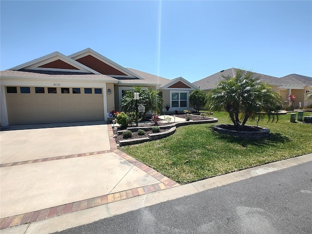 view of front facade with concrete driveway, an attached garage, a shingled roof, a front yard, and stucco siding