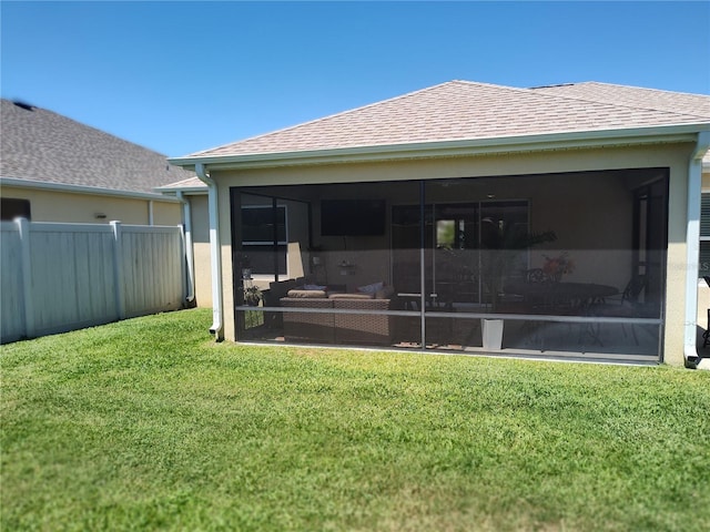 6030 Dijulio Ter, The Villages, FL 32163 - rear view of property with a lawn, an outdoor living space, fence, a sunroom, and roof with shingles