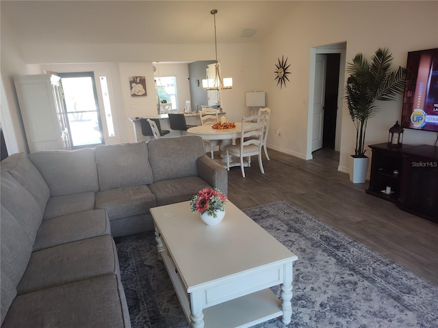 6030 Dijulio Ter, The Villages, FL 32163 - living room featuring an inviting chandelier, lofted ceiling, baseboards, and dark wood finished floors